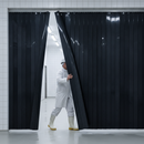 Solid black PVC strip curtains in UK abattoir / meat processing facility — complete hygiene and privacy barrier
